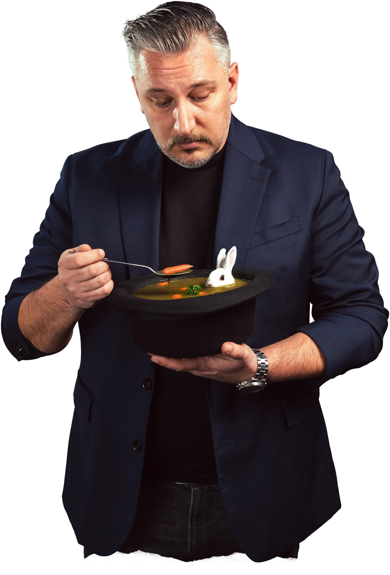Mario Westerwelle löffelt Suppe aus einem Zylinder, in dem ein Kaninchen sitzt